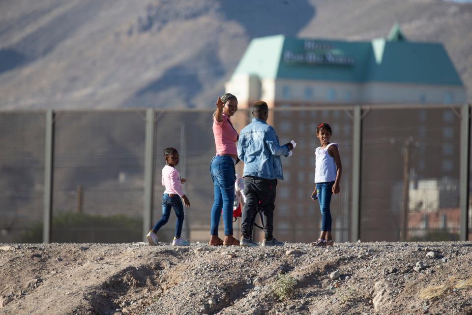 A Haitian family crosses the Rio Grande from Juárez to El Paso on May 17. The family evaded the Mexican National Guard and quickly crossed the river embankment and turned themselves in to U.S. Customs and Border Protection officers on the U.S. side of the border.