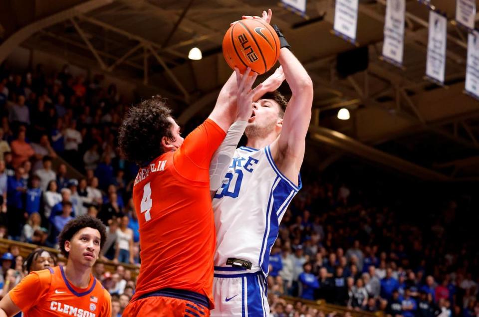 Duke’s Kyle Filipowski (30) is fouled by Clemson’s Ian Schieffelin (4) as Filipowski makes the shot with 15 seconds left in the game during Duke’s 72-71 victory over Clemson at Cameron Indoor Stadium in Durham, N.C., Saturday, Jan. 27, 2024.