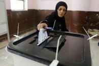 A voter casts her ballot on constitutional amendments during the first day of three-day voting at a polling station in Cairo, Egypt, Saturday, April 20, 2019. Egyptians are voting on constitutional amendments that would allow President Abdel-Fattah el-Sissi to stay in power until 2030. (AP Photo/Amr Nabil)