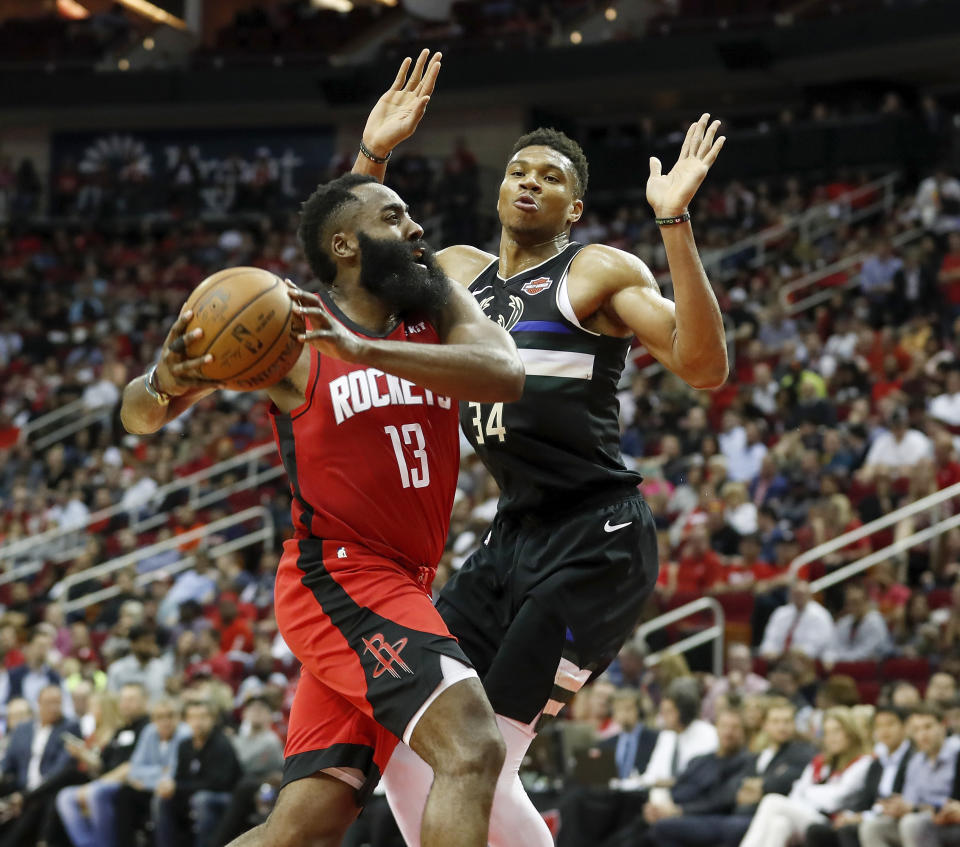 Houston's James Harden drives to the basket defended by Milwaukee's Giannis Antetokounmpo at Toyota Center on Oct. 24, 2019. (Photo by Tim Warner/Getty Images)