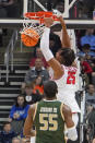 Houston 's Josh Carlton (25) dunks behind UAB 's Trey Jemison (55) during the first half of a college basketball game in the first round of the NCAA tournament in Pittsburgh, Friday, March 18, 2022. (AP Photo/Gene J. Puskar)