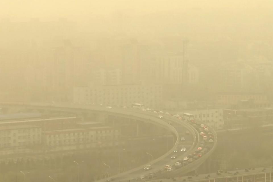 FILE - Cars drive along a highway shot through a glass window during a dust storm amid heavy pollution in Beijing, March 10, 2023. Almost the entire world breathes air that exceeds the World Health Organization's air-quality limits at least occasionally. (AP Photo/Borg Wong, File)