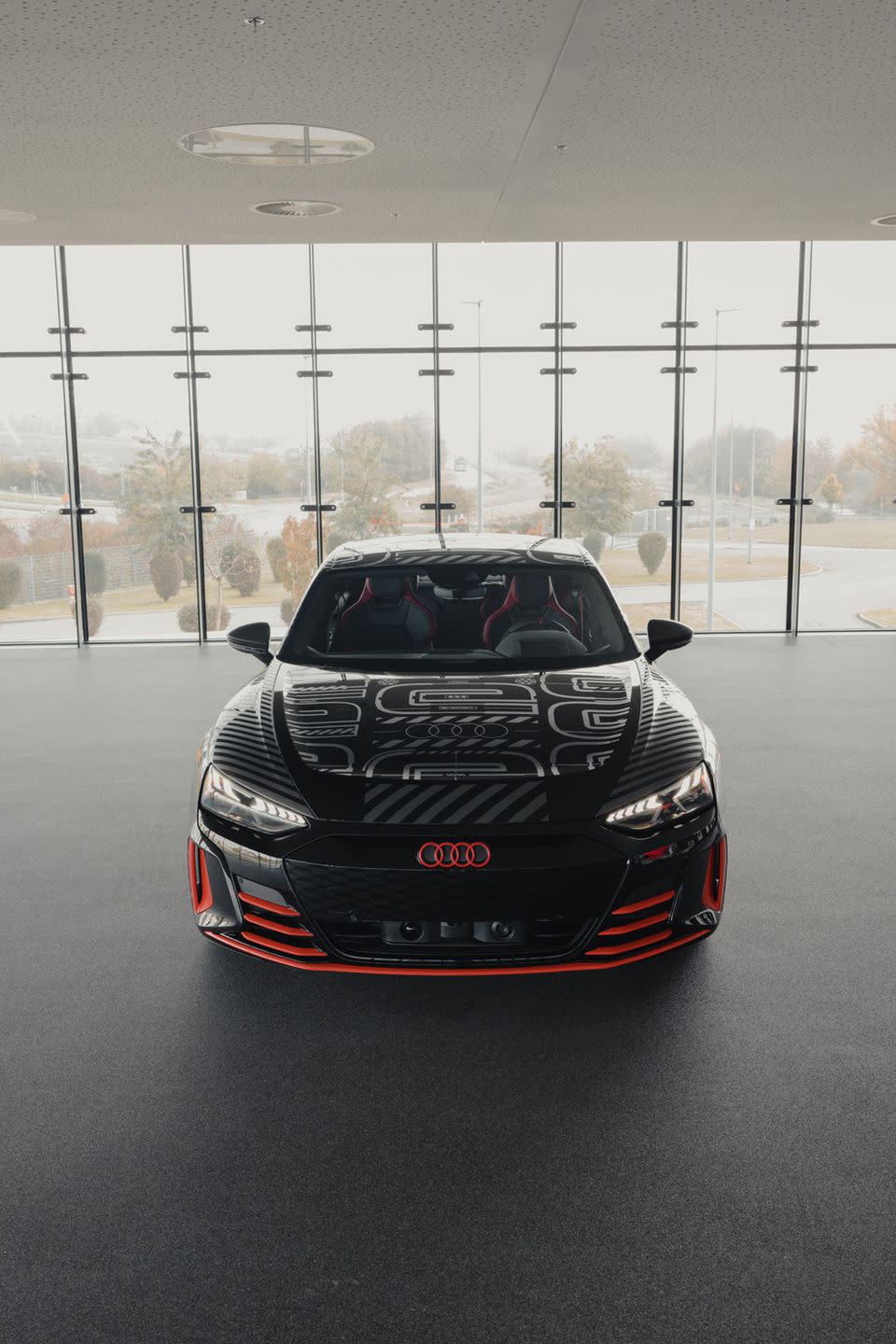 <p>The gray and black wrap features red accents on the lower sections of the car and the front and rear Audi logos.</p>