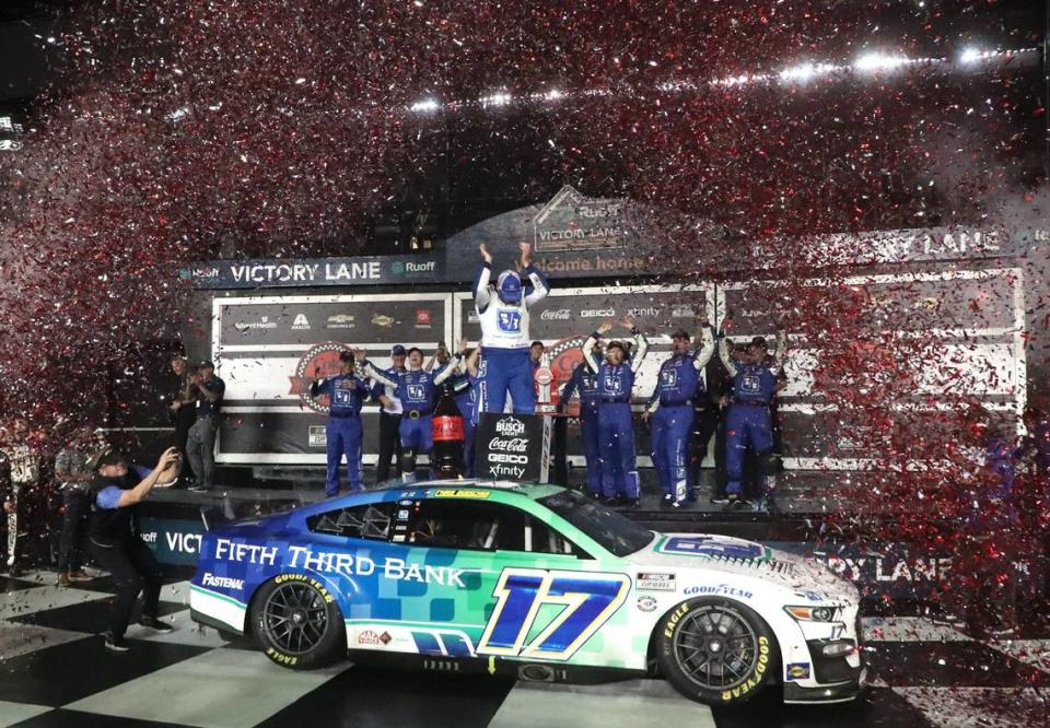 Chris Buescher stands on hiis no. 17 Ford Mustang in Victory Lane, Saturday August 26, 2023 after winning the Coke Zero Sugar 400 at Daytona International Speedway.