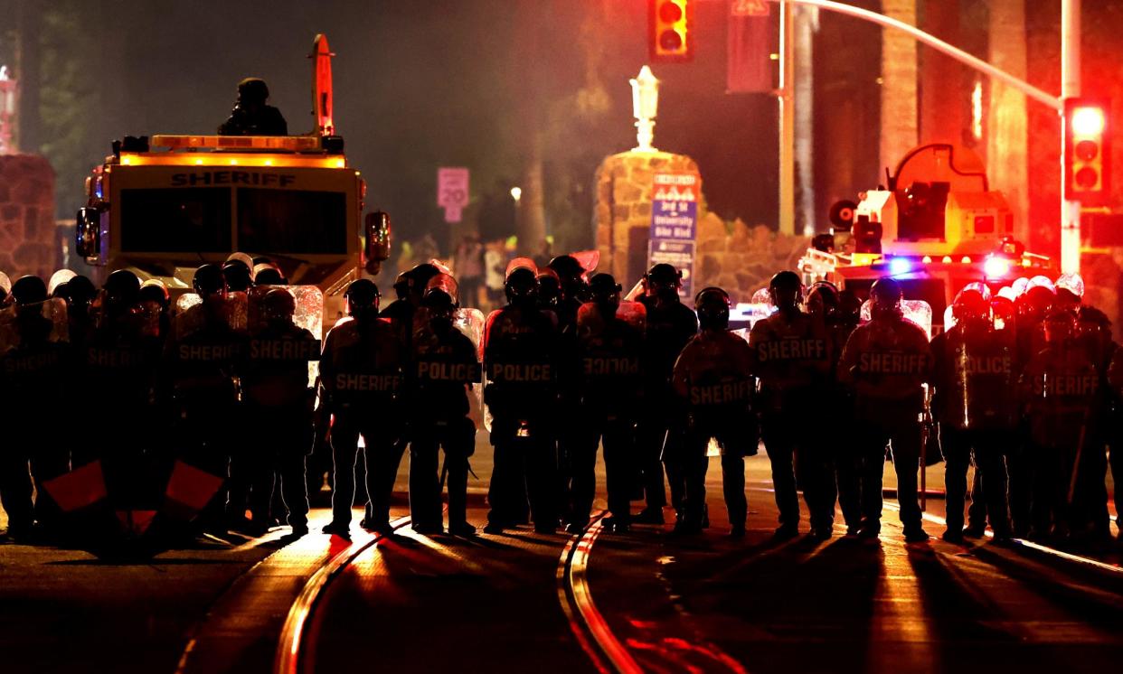 <span>Police gather after ejecting a group of pro-Palestinian demonstrators off the University of Arizona campus in Tucson on 10 May 2024.</span><span>Photograph: Kelly Presnell/AP</span>