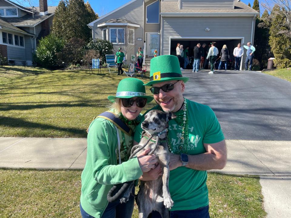Beth Barber and Ron Epstein pose with their dog Pepper at the Belmar Lake Como St. Patrick's Day Parade on March 3, 2024.
