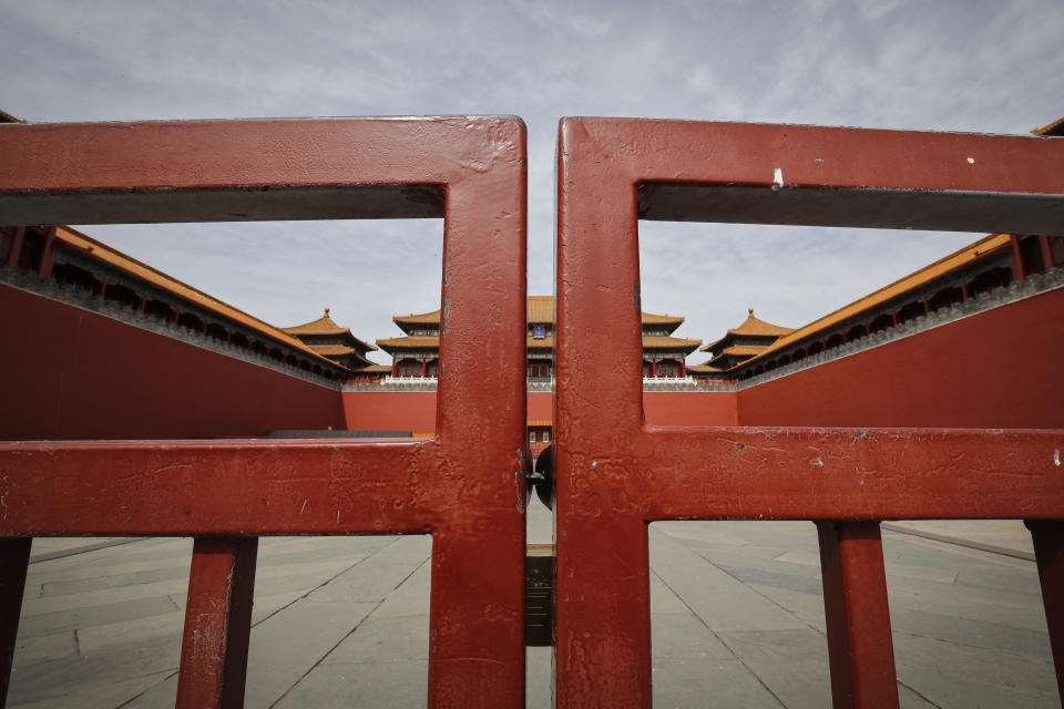 FILE - In this Thursday, March 12, 2020 file photo, an entrance gate is closed at the usually crowded Forbidden City in Beijing, due to the COVID-19 coronavirus outbreak. Throughout January, the World Health Organization publicly praised China for what it called a speedy response to the new coronavirus. It repeatedly thanked the Chinese government for sharing the genetic map of the virus “immediately,” and said its work and its commitment to transparency were “very impressive, and beyond words.” But behind the scenes, it was a much different story, one of significant delays by China and considerable frustration among WHO officials over not getting the information they needed to fight the spread of the deadly virus, The Associated Press has found. (AP Photo/Andy Wong)