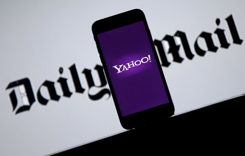 Smartphone with Yahoo logo is seen in front of a displayed Daily Mail logo in this illustration taken April 11, 2016. REUTERS/Dado Ruvic/Illustration