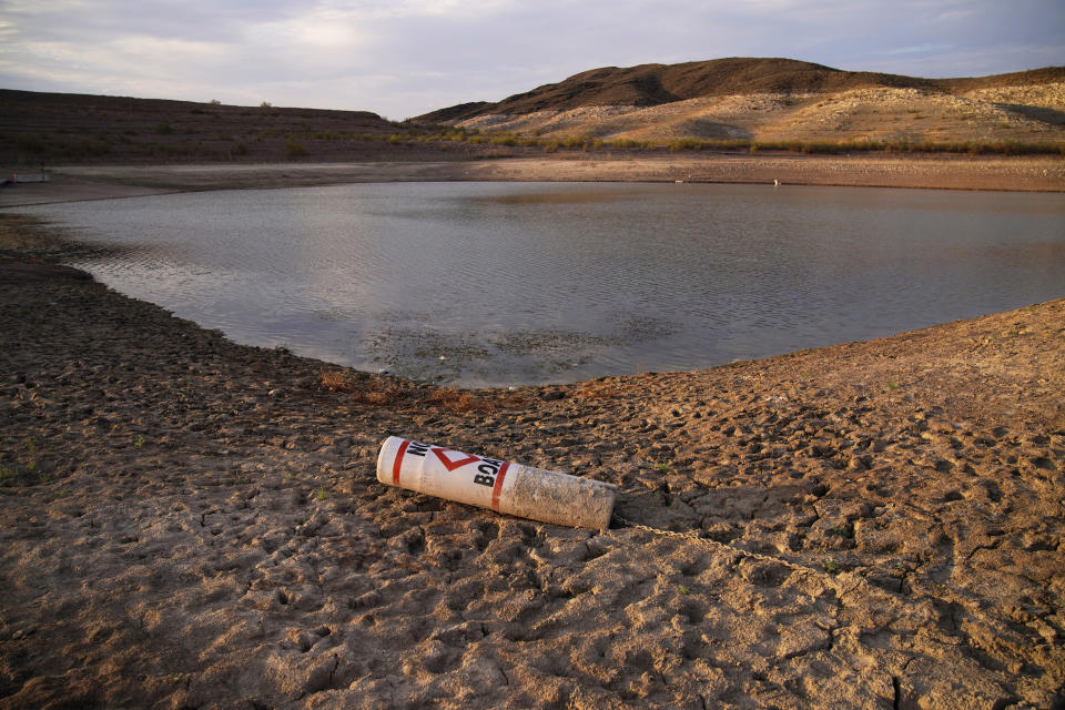 FILE - A buoy rests on the ground at a closed boat ramp on Lake Mead at the Lake Mead National Recreation Area near Boulder City, Nev., on Aug. 13, 2021. A Native American tribe has agreed to lease more of its water to help address dwindling supplies in the Colorado River Basin, officials announced Thursday, Jan. 20, 2022. The agreement involves the Jicarilla Apache Nation, the New Mexico Interstate Stream Commission and The Nature Conservancy. The water would be released from the Navajo Reservoir in northwestern New Mexico to feed the San Juan River, which flows into the Colorado River. (AP Photo/John Locher, File)