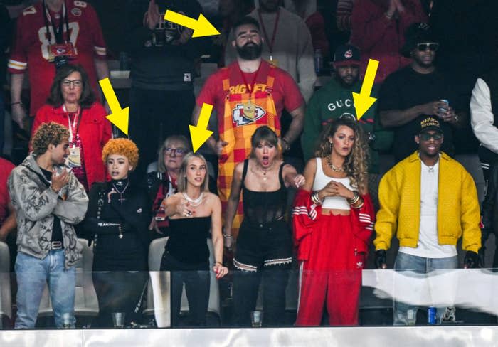 Group of seven people stands at a sporting event. Notable: Ice Spice, Sophie Turner, Taylor Swift and Blake Lively each wore outfits ranging from casual to stylish