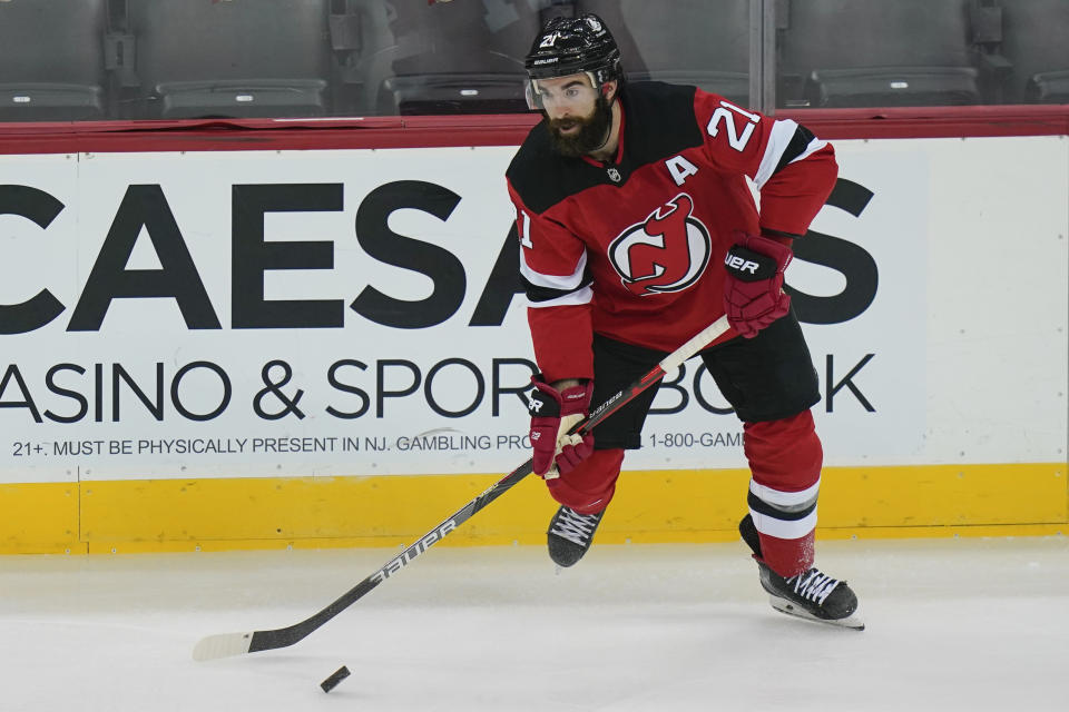 FILE - New Jersey Devils' Kyle Palmieri (21) moves the puck during the first period of an NHL hockey game against the Philadelphia Flyers in Newark, N.J., in this Thursday, Jan. 28, 2021, file photo. The NHL trade deadline is less than a week away and players such as Taylor Hall, Kyle Palmieri, Mikael Granlund and Mattias Ekholm are potentially available for teams willing to make a deal. (AP Photo/Frank Franklin II, File)
