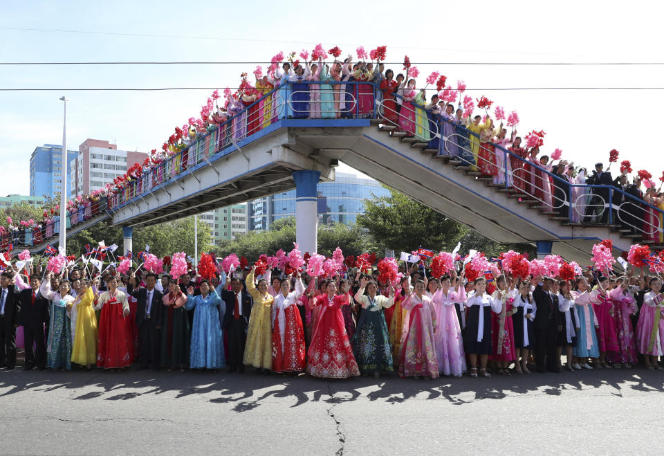 North Koreans fill the streets of Pyongyang to welcome South Korean President Moon Jae-in and the North Korean leader Kim Jong Un passing by during a car parade in North Korea, Tuesday, Sept. 18, 2018. (Pyongyang Press Corps Pool via AP)