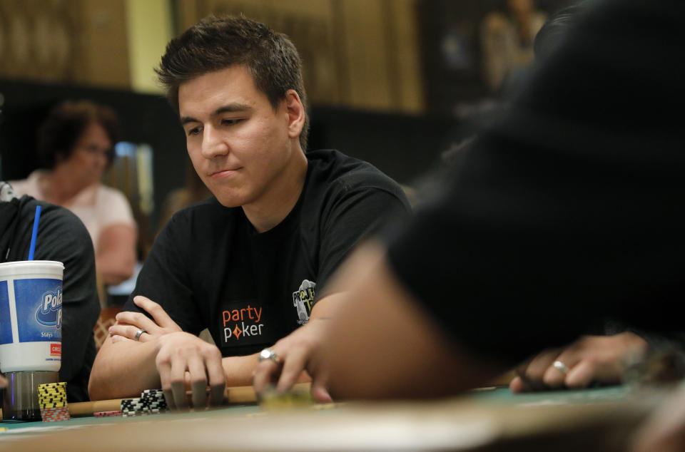 FILE - In this Monday, June 24, 2019, file photo, "Jeopardy!" champion and professional sports gambler James Holzhauer plays in a tournament at the World Series of Poker, in Las Vegas. The three top money winners in “Jeopardy!” history, Ken Jennings, Brad Rutter and James Holzhauer, will vie for a share of $1.5 million in January 2020. (AP Photo/John Locher, File)