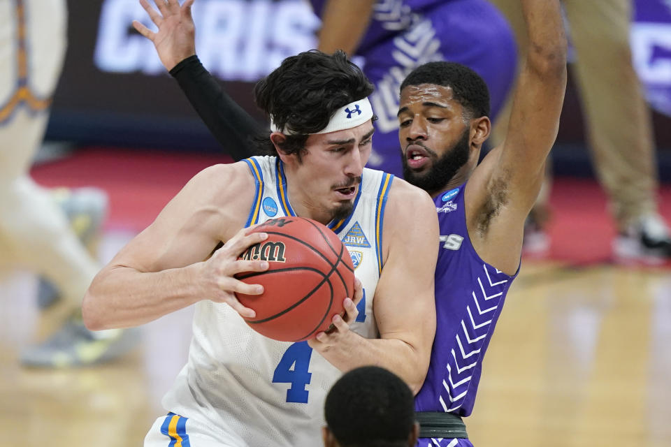 UCLA's Jaime Jaquez Jr. (4) drives against Abilene Christian's Reggie Miller during the first half of a college basketball game in the second round of the NCAA tournament at Bankers Life Fieldhouse in Indianapolis Monday, March 22, 2021. (AP Photo/Mark Humphrey)