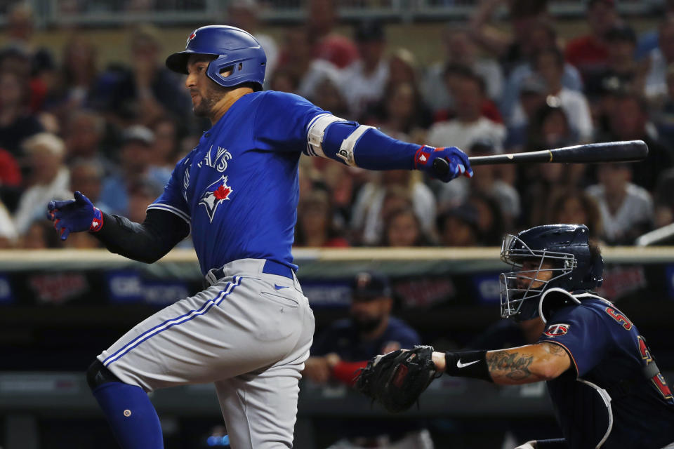 Toronto Blue Jays' George Springer watches his two-run single against the Minnesota Twins during the eighth inning of a baseball game Thursday, Aug. 4, 2022, in Minneapolis. (AP Photo/Bruce Kluckhohn)