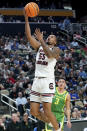 South Carolina's Ta'Lon Cooper (55) shoots in front of Oregon's Jackson Shelstad (3) during the first half of a first-round college basketball game in the NCAA Tournament, Thursday, March 21, 2024, in Pittsburgh. (AP Photo/Matt Freed)