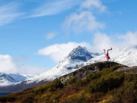 A girl stands on her hands near Vang, Norway. Svein Nordrum/NTB Scanpix/via REUTERS