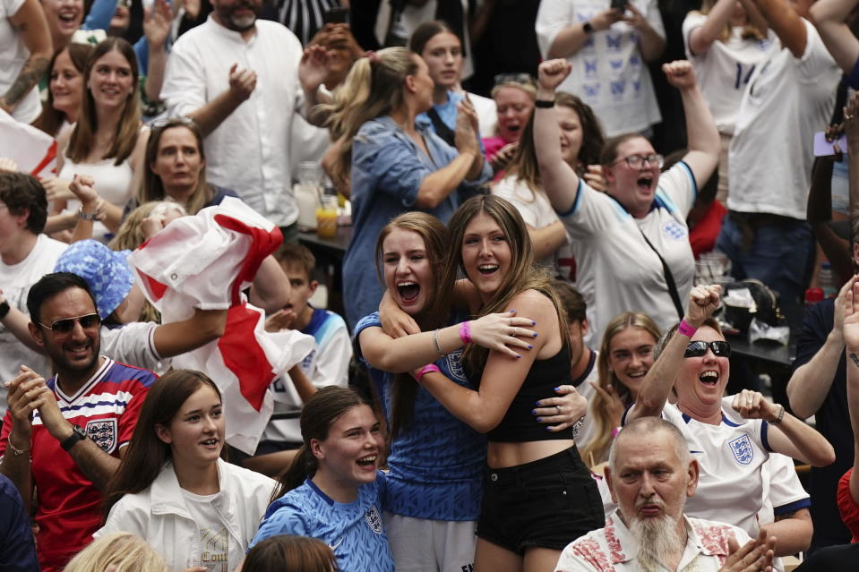 England fans celebrate following a screening of the FIFA Women's World Cup 2023 semi-final at BOXPARK Croydon, London, Wednesday Aug. 16, 2023. England will play Spain in the final of the Women's World Cup on Sunday after beating co-hosts Australia 3-1 in the semi-final in Sydney. (Aaron Chown/PA via AP)