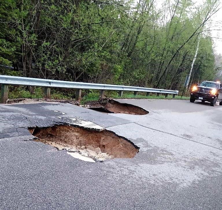 These sections of West Rost Lake Road collapsed Friday when Todd Radloff of Coleman drove over them about 5 a.m. The crash flattened three tires and ruined the gas tank of his pickup. The road was weakened by heavy rains Thursday night.