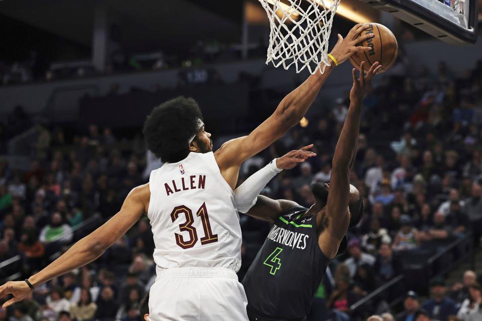 Cleveland Cavaliers center Jarrett Allen (31) blocks Minnesota Timberwolves guard Jaylen Nowell (4) during the first half of an NBA basketball game Saturday, Jan. 14, 2023, in Minneapolis. (AP Photo/Stacy Bengs)