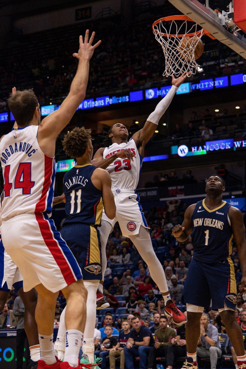 Pistons guard Jaden Ivey drives to the basket against Pelicans guard Dyson Daniels, left, and forward Zion Williamson in the first half on Wednesday, Dec. 7, 2022, in New Orleans.