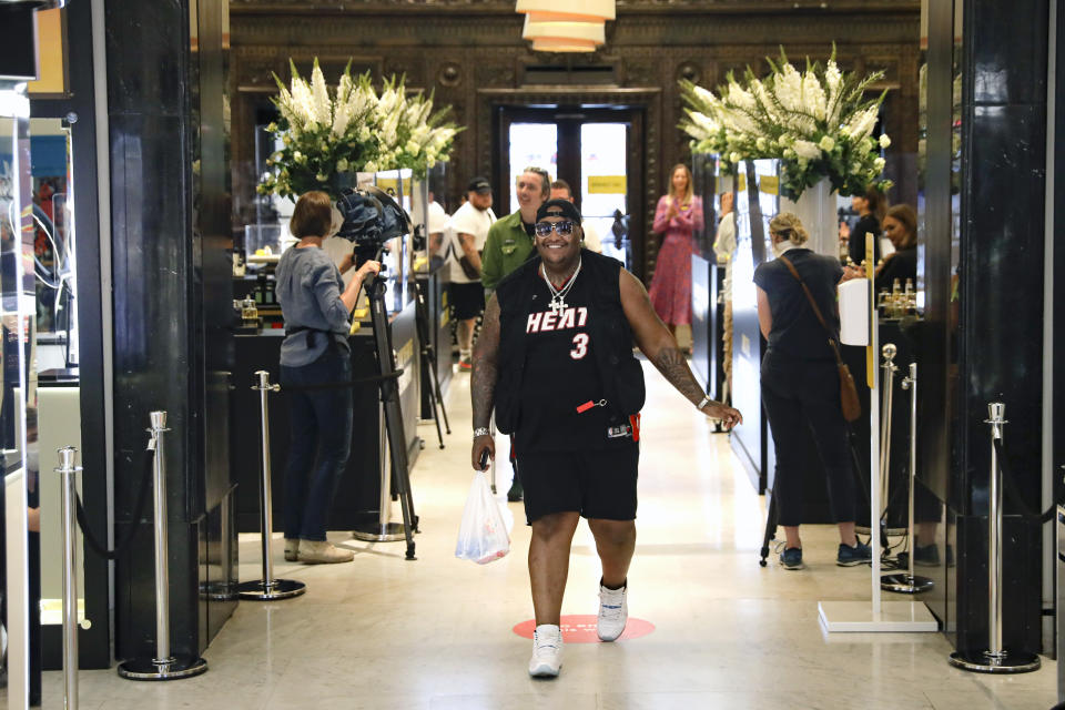 Customers enter the Selfridges department store in London, Monday, June 15, 2020. After three months of being closed under coronavirus restrictions, shops selling fashion, toys and other non-essential goods are being allowed to reopen across England for the first time since the country went into lockdown in March.(AP Photo/Matt Dunham)