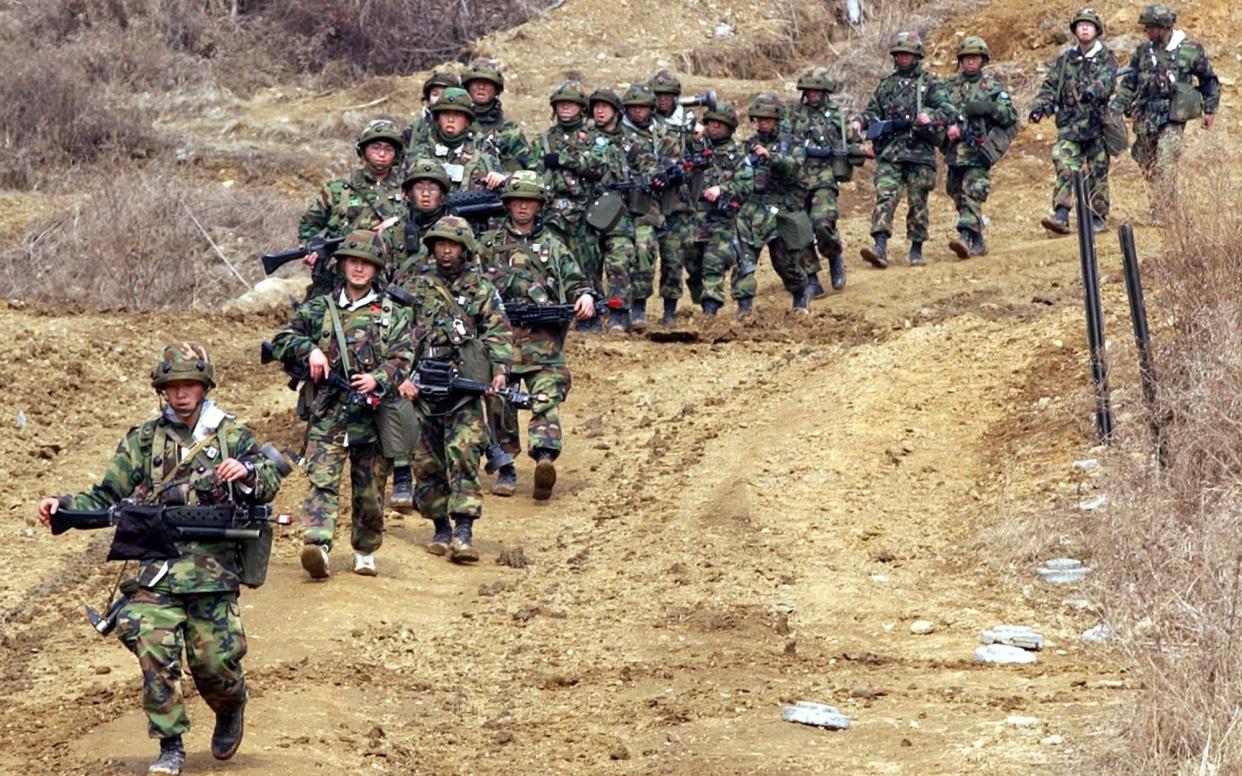 South Korean soldiers make their way to other position during a military training operation  - AP