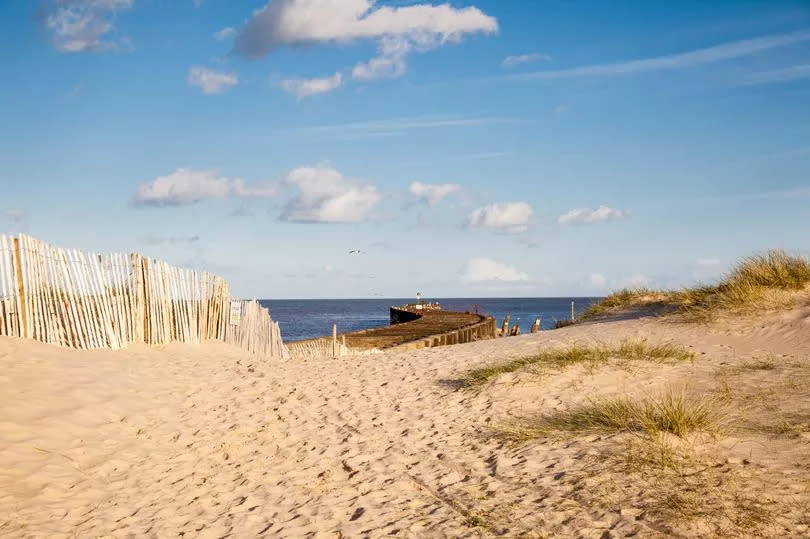 Sand dunes and a pier in Walberswick, Suffolk