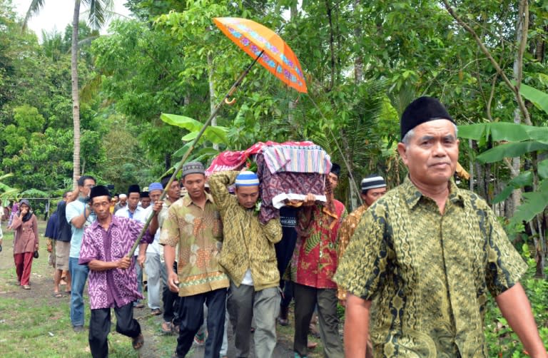 Relatives and villagers carry the coffin of Sumarti Ningsih, one of two Indonesian women allegedly murdered by British banker Rurik Jutting in Hong Kong, during her funeral in Central Java province, on November 12, 2014