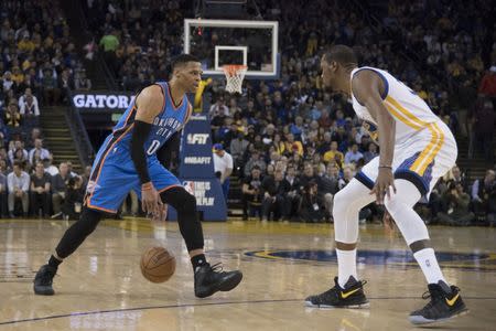 January 18, 2017; Oakland, CA, USA; Oklahoma City Thunder guard Russell Westbrook (0) dribbles the basketball against Golden State Warriors forward Kevin Durant (35) during the third quarter at Oracle Arena. Mandatory Credit: Kyle Terada-USA TODAY Sports