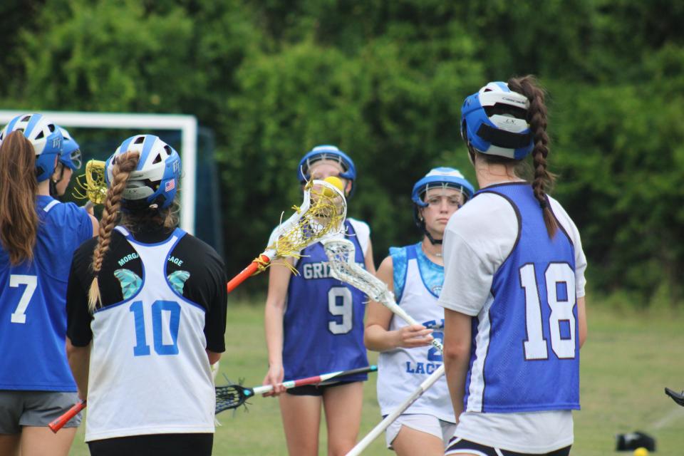 Bartram Trail girls lacrosse players pass the ball in a circle during practice on May 6, 2024. [Clayton Freeman/Florida Times-Union]