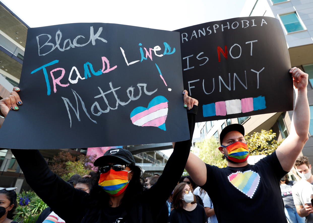 People attend a rally in support of the Netflix transgender employee walkout 