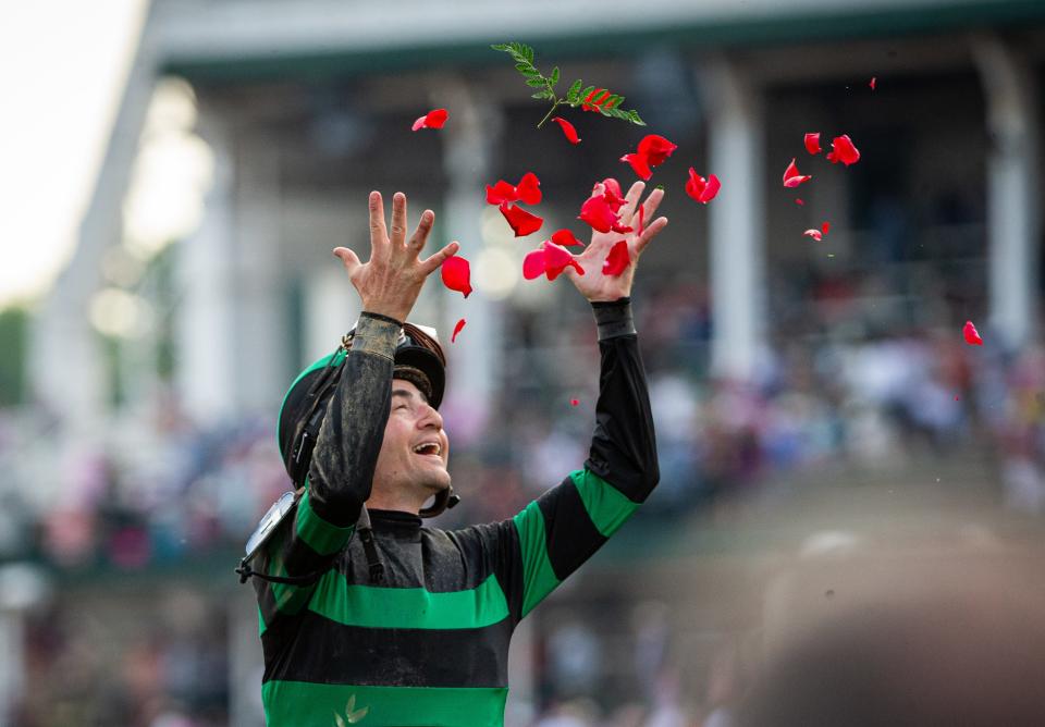 Jockey Brian Hernandez Jr. tossed rose petals in the winner's circle Saturday after riding Mystik Dan to victory in a photo finish in the 150th Kentucky Derby at Churchill Downs.