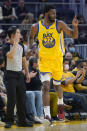 Golden State Warriors forward Andrew Wiggins (22) gestures after scoring against the Toronto Raptors during the first half of an NBA basketball game in San Francisco, Sunday, Nov. 21, 2021. (AP Photo/Jeff Chiu)