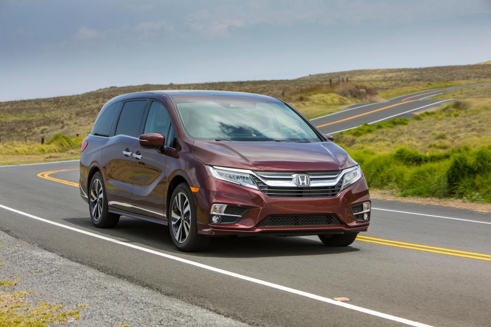 A red 2019 Honda Odyssey on a road.