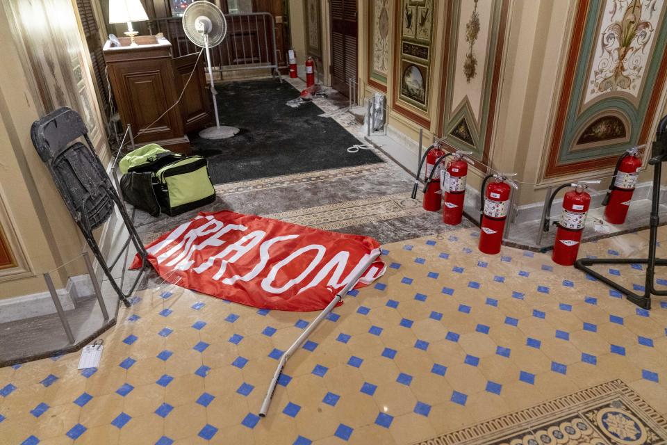 A flag that reads "Treason" is visible on the ground in the early morning hours of Thursday, Jan. 7, 2021, after protesters stormed the Capitol in Washington, on Wednesday. (AP Photo/Andrew Harnik)