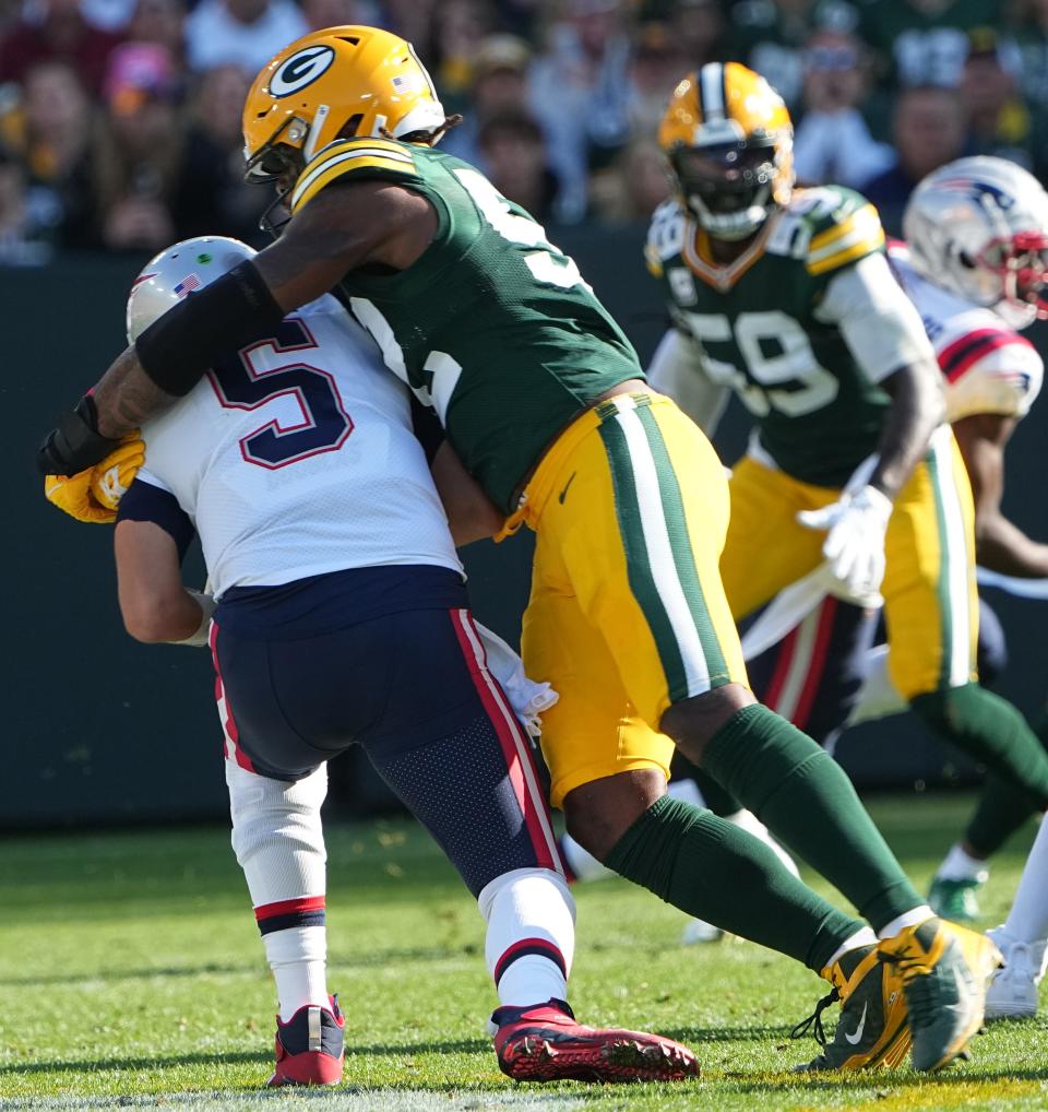 Green Bay Packers' Rashan Gary (52) sacks New England Patriots quarterback Brian Hoyer (5) during the first quarter of their game against the New England Patriots Sunday, October 2, 2022 at Lambeau Field in Green Bay, Wis.MARK HOFFMAN/MILWAUKEE JOURNAL SENTINEL