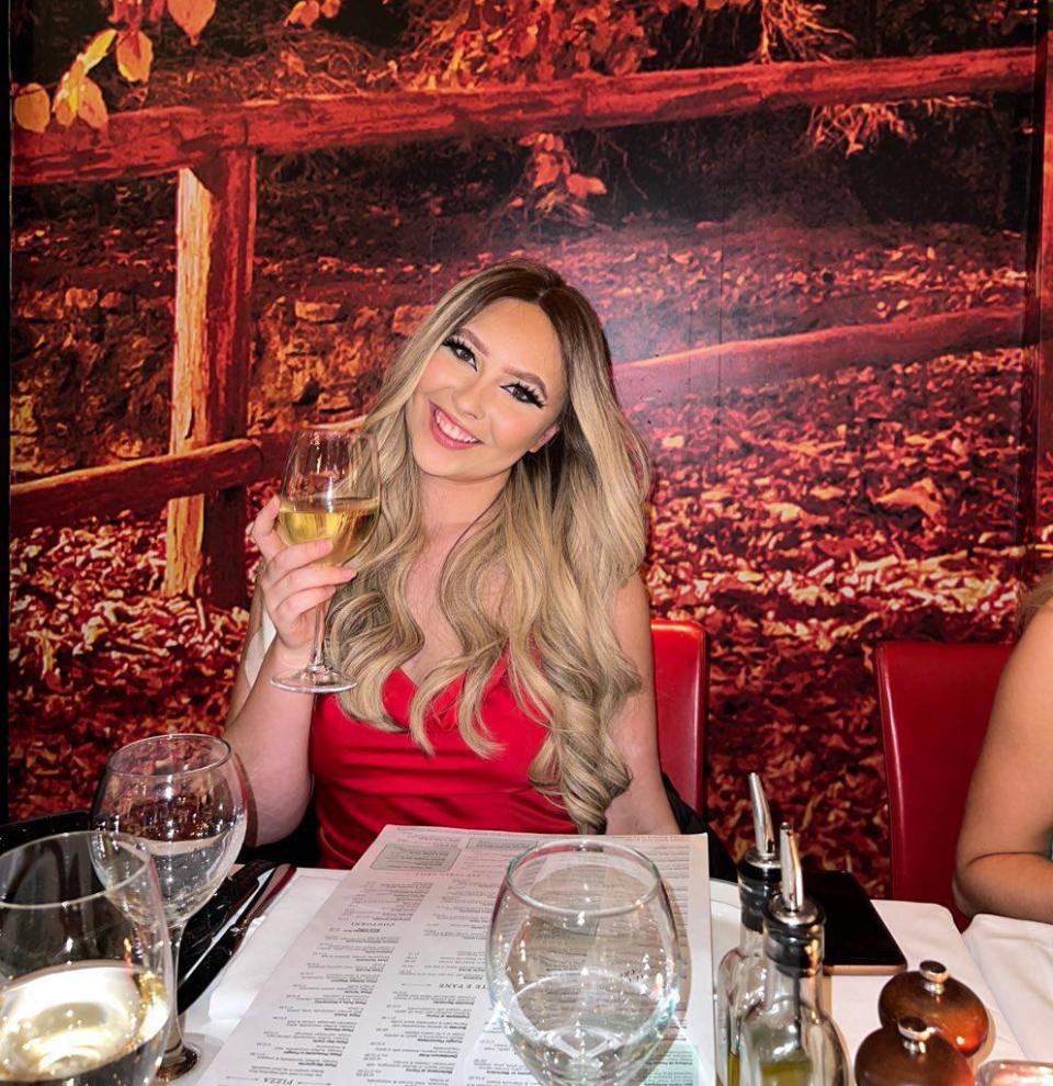 Eloise wearing a red dress at a restaurant.