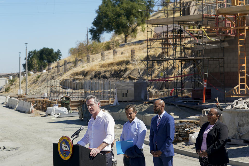 Governor Gavin Newsom, center, talks to reporters during a press conference at the construction site of a water desalination plant in Antioch, Calif., Thursday, Aug. 11, 2022. (AP Photo/Godofredo A. Vásquez)