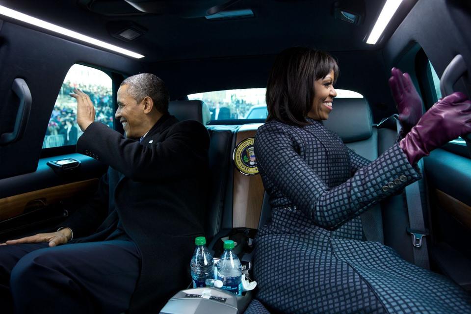 Barack and Michelle Obama ride in the presidential limousine in2013