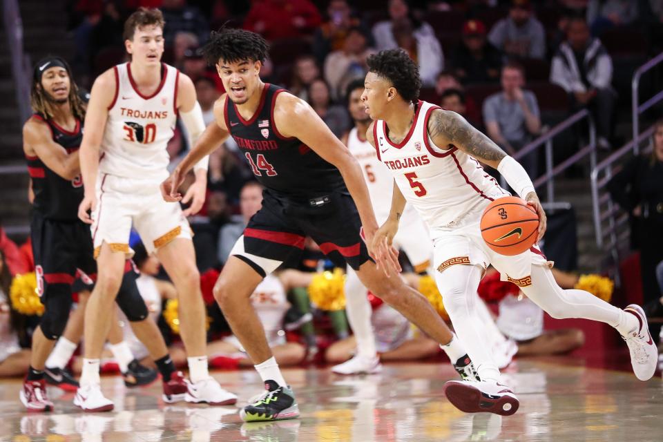 LOS ANGELES, CALIFORNIA - JANUARY 06: Boogie Ellis #5 of the USC Trojans handles the ball in the second half defended by Spencer Jones #14 of the Stanford Cardinal at Galen Center on January 06, 2024 in Los Angeles, California. (Photo by Meg Oliphant/Getty Images)