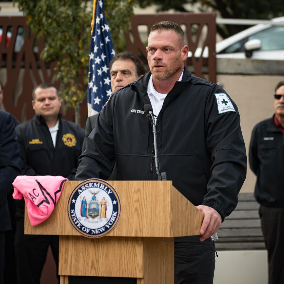 Chief Tom Meyers of Central Oneida County Volunteer Ambulance Company, alongside lawmakers and other ambulance service providers, speaks during a unified call to action urging Governor Kathy Hochul to sign the "direct pay" legislation into law at the Utica State Office Building in Utica, NY on Thursday, October 12, 2023.