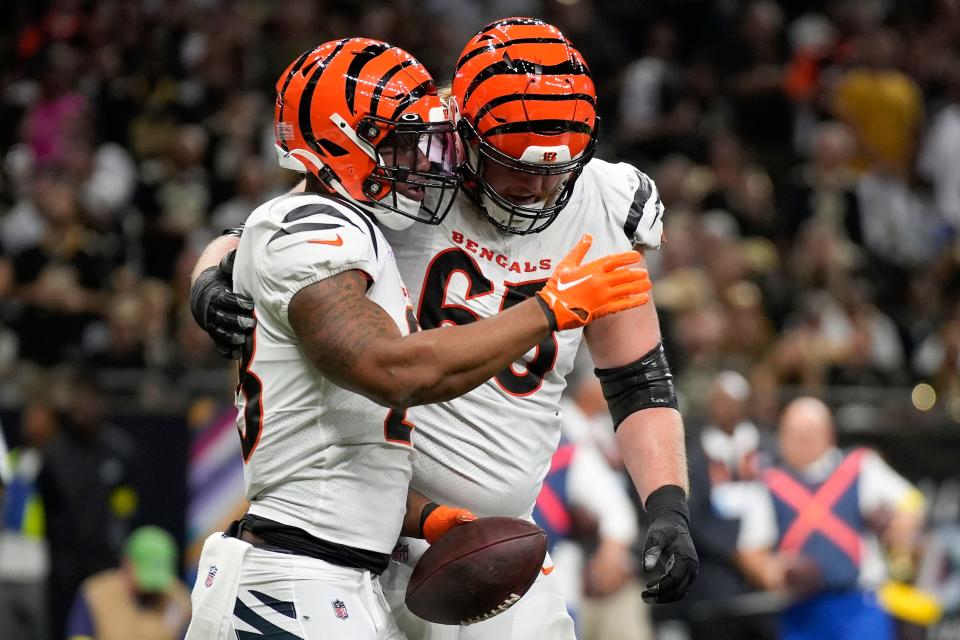 Cincinnati Bengals guard Alex Cappa congratulates running back Joe Mixon after a touchdown. Mixon has responded to a frustrating first month of the season.