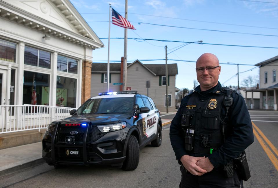 Chief of the Pleasantville Police Department Nick Garver as he stands next to one the Pleasantville police cruisers on Feb. 14, 2024, in Pleasantville, Ohio.