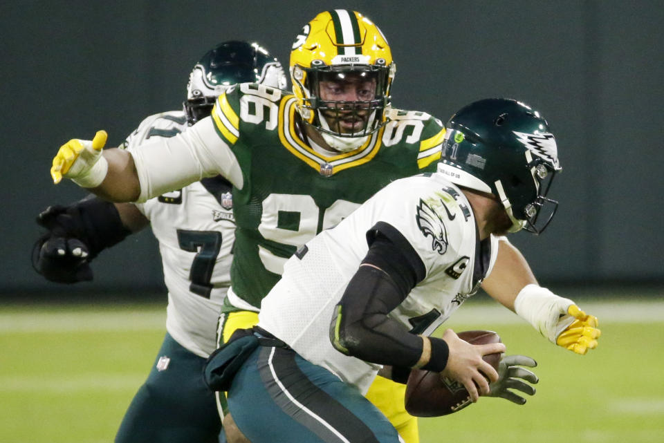Green Bay Packers' Kingsley Keke sacks Philadelphia Eagles' Carson Wentz during the first half of an NFL football game Sunday, Dec. 6, 2020, in Green Bay, Wis. (AP Photo/Mike Roemer)