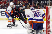 Carolina Hurricanes' Sebastian Aho (20) shoots the puck at New York Islanders goaltender Semyon Varlamov (40) while battling Islanders' Ryan Pulock (6) during the second period in Game 1 of an NHL hockey Stanley Cup first-round playoff series in Raleigh, N.C., Saturday, April 20, 2024. (AP Photo/Karl B DeBlaker)