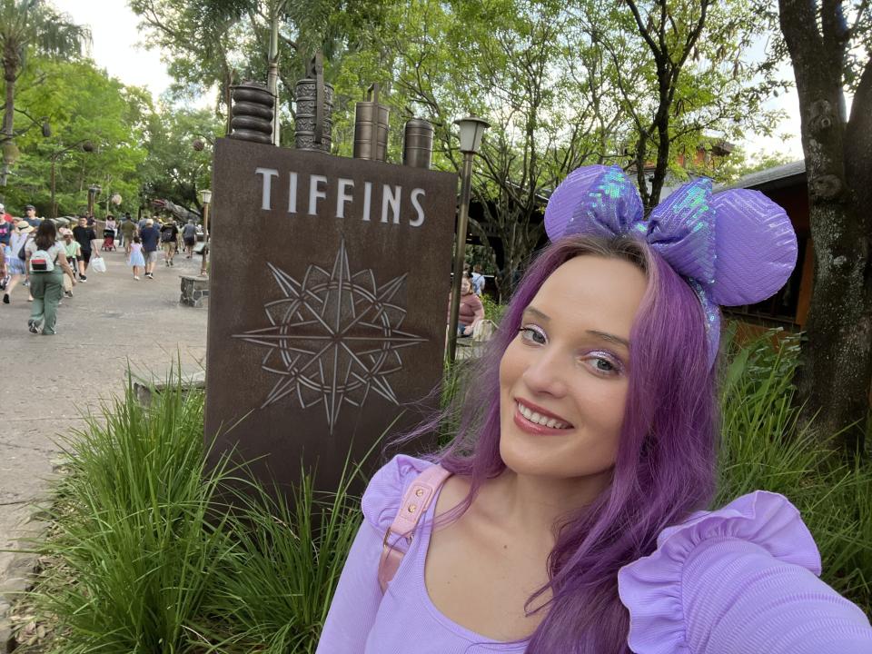 Author taking a selfie in front of Tiffins wooden sign.