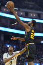 Golden State Warriors forward Andrew Wiggins (22) shoots over Utah Jazz forward Rudy Gay (8) during the first half of an NBA basketball game in San Francisco, Sunday, Jan. 23, 2022. (AP Photo/Jeff Chiu)