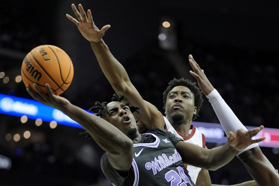 Kansas State forward Arthur Kaluma (24) gets past Iowa State forward Hason Ward to put up a shot during the first half of an NCAA college basketball game in the quarterfinal round of the Big 12 Conference tournament, Thursday, March 14, 2024, in Kansas City, Mo. (AP Photo/Charlie Riedel)