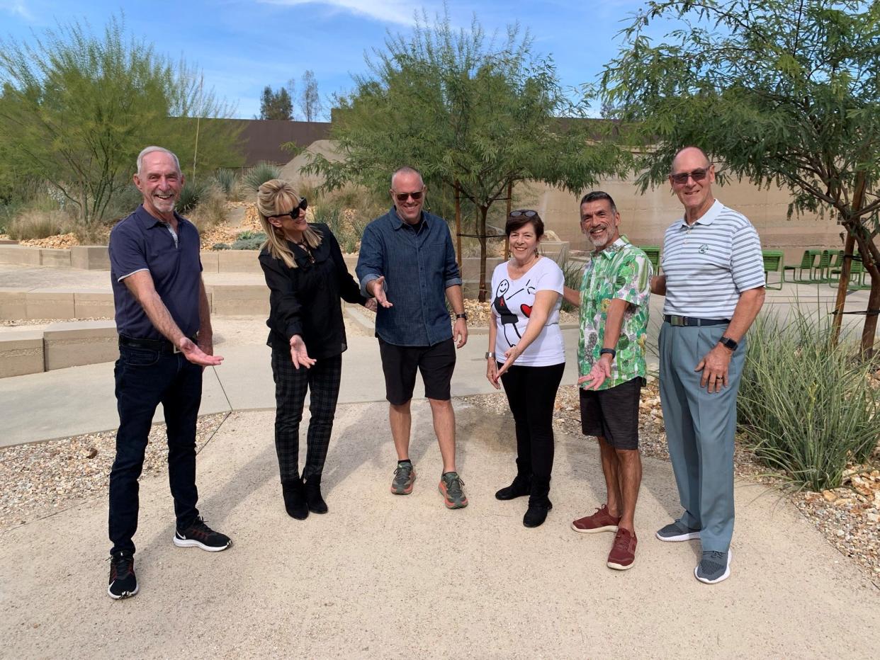Sandie Newton poses with Members of the Palm Springs AIDS Memorial Task Force — Mike Richey, Sandie, Phillip K. Smith III, Ann Sheffer, Arturo Fernandez, Jeffrey Jurasky — who point to the future location of the AIDS Memorial Sculpture.